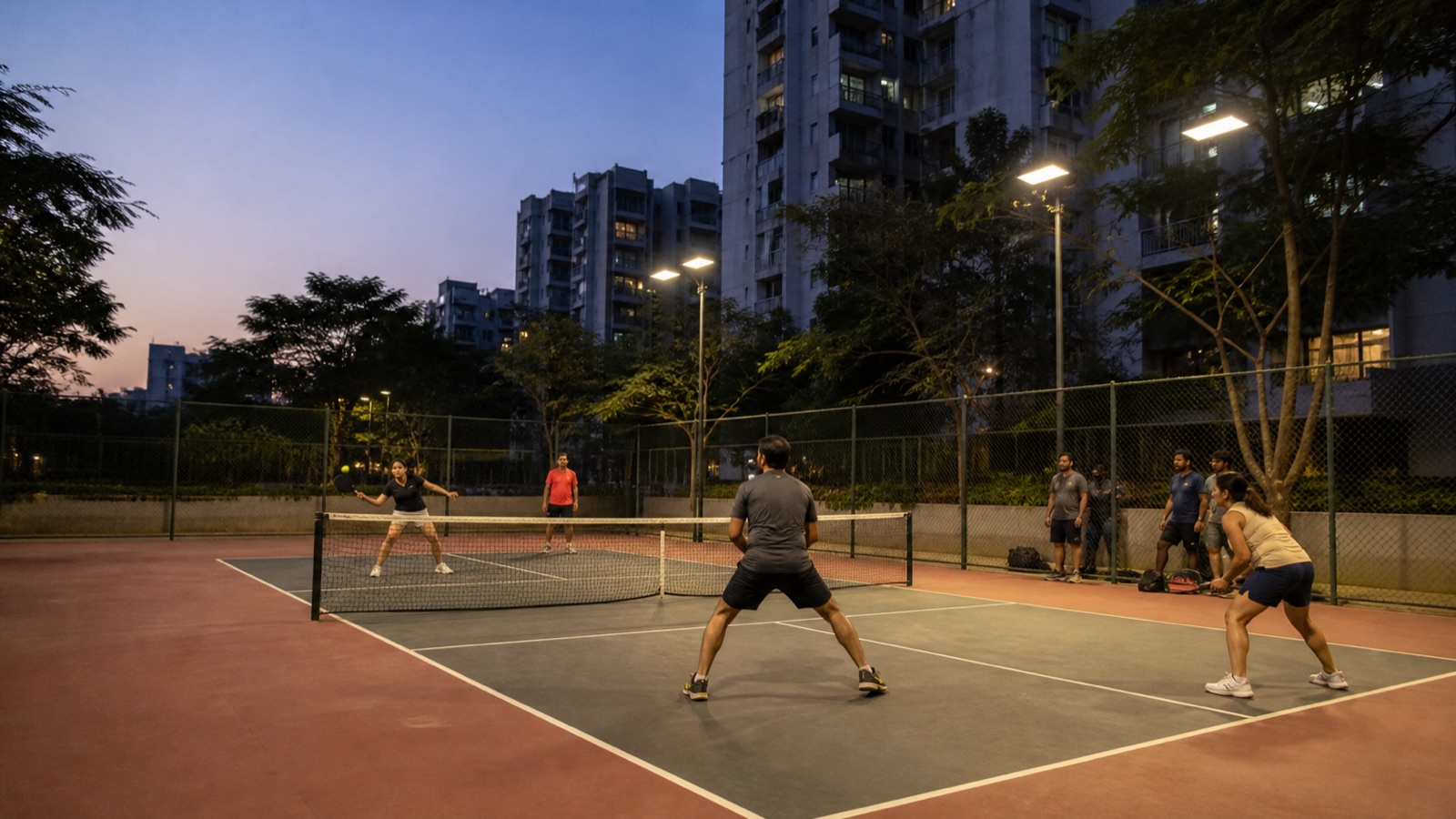 A lit pickleball court in an Indian city